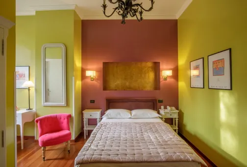 Superior Single room at Fenix Hotel Roma with a French double bed and an armchair