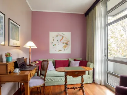 Sitting area of the Executive Double room with sofa, coffee table and writing desk