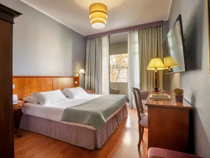 Double bed and writing desk in the Executive Double room